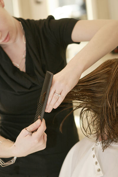 Woman getting her haircut in a salon