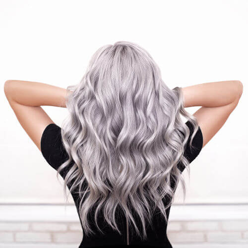 Back view of beautiful woman's glossy, wavy, silver grey hair
